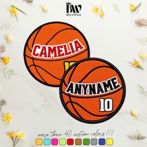May include: Two circular embroidered basketball patches with black borders. The top patch features the name CAMELIA in red letters with white outlines. The bottom patch displays the text ANYNAME in black letters with white outlines and the number 10.
