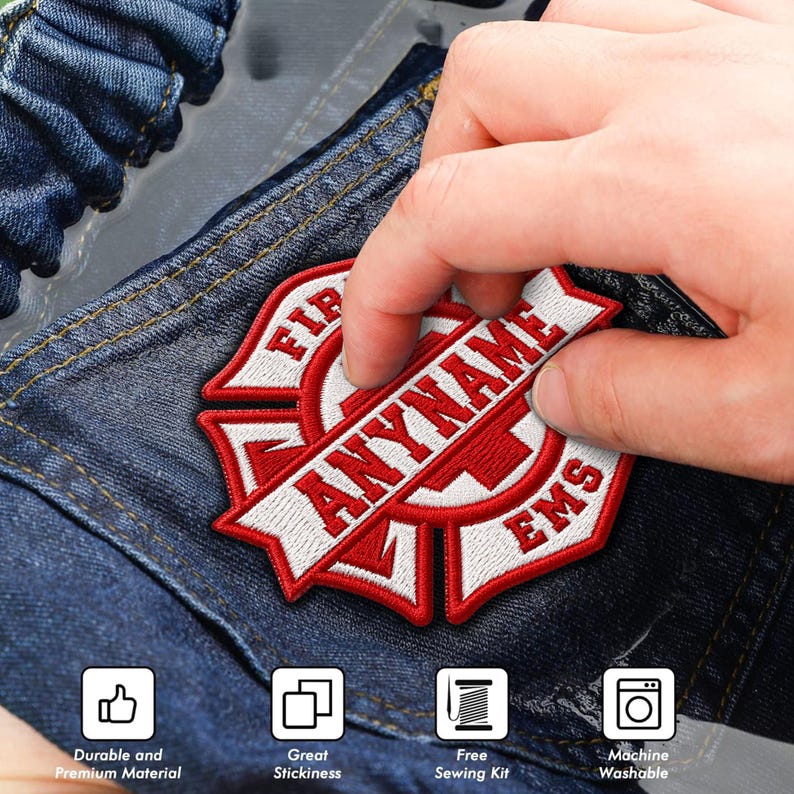 May include: A red and white embroidered patch featuring a Maltese cross design with the text ANYNAME and EMS. The patch is applied to dark blue denim fabric. Four square icons at the bottom indicate durable material, stickiness, sewing kit, and washability.