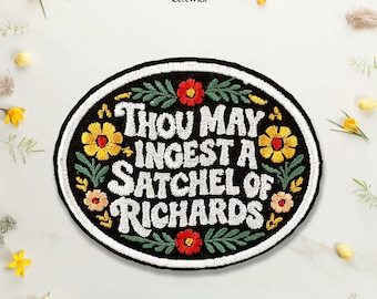 May include: An oval embroidered patch with a black background and a white border. The text reads "THOU MAY INGEST A SATCHEL OF RICHARDS" in white letters. The design is decorated with embroidered yellow, red, and pink flowers and green leaves.
