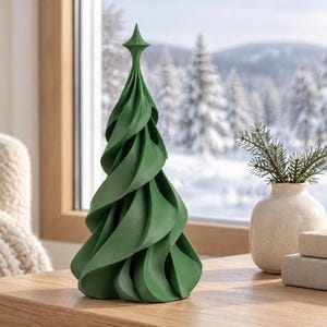 May include: A matte dark green decorative tree sculpture featuring a spiraling, twisted design that tapers to a pointed top. The object has a smooth, solid surface and a conical shape, standing upright as a standalone piece of decor.