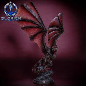 May include: A detailed dragon figurine with large, textured dark red wings and a dark grey body, standing on a rocky base. A small human figure stands near the dragon's tail. The base features a small emblem, and the logo OLDRICH is visible.