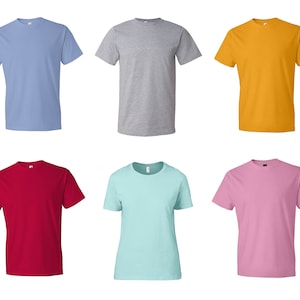 May include: A collection of six short-sleeved crew neck t-shirts displayed in two rows. The top row features light blue, heather gray, and golden yellow shirts. The bottom row includes deep red, light turquoise, and soft pink t-shirts.