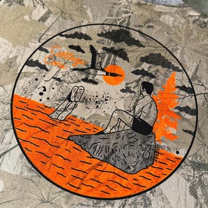 May include: A set of three ceramic mugs with a speckled, matte finish. Each mug features a different color: light blue, cream, and gray. The mugs have a simple, modern design with a rounded shape and a comfortable handle.