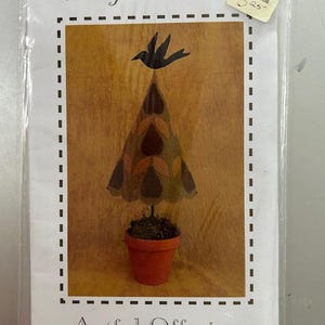 May include: A craft pattern for a felt avocado tree with a black bird on top. The pattern is titled "Growing About Avocado" and is from Artful Offerings. The pattern is $2.25.