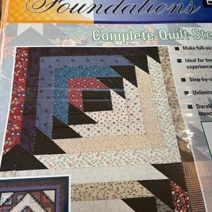 May include: A Fiskars Foundations Complete Quilt Steps package. The package features a colorful quilt block design with various fabric patterns and colours, including blue, red, and floral prints. The text "Log Cabin with Steps" is visible.