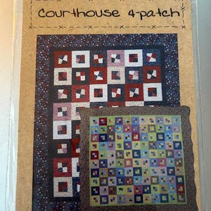 May include: A package for a Courthouse 4-patch quilt pattern. The pattern includes instructions for a queen and crib quilt, table runner, and table topper. The design features a red, white, and blue color scheme with a star-patterned border.