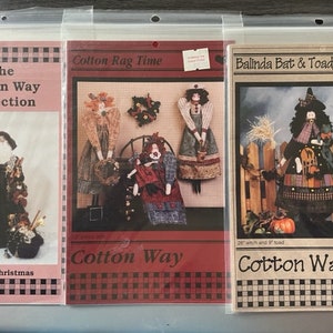 May include: Three sewing patterns for rag dolls, featuring a witch, a Christmas character, and a woman in a red dress. The patterns are titled "Balinda Bat & Toady", "Father Christmas", and "Cotton Rag Time". All three patterns are part of the "Cotton Way Collection".