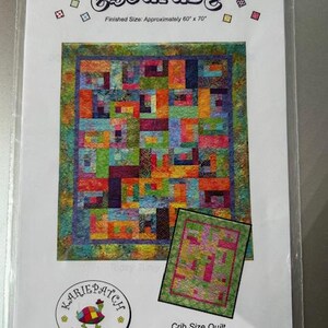 May include: A quilt pattern titled "escapade" with a finished size of approximately 60 x 70 inches. The pattern features a colorful patchwork design. The package includes instructions for a crib size quilt. The logo for "KariePatch Designs" is also visible.