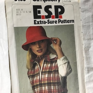 May include: Vintage Simplicity sewing pattern 8165 for a plaid vest and hat. The pattern is for sizes 10, 12, and 14. The pattern is called "ESP Extra-Sure Pattern".