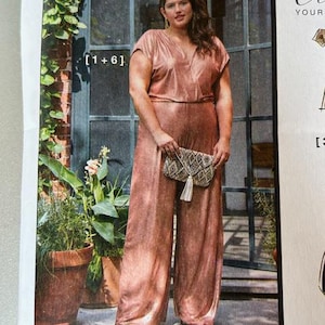 May include: A rose gold jumpsuit with wide legs and short sleeves. The outfit is paired with a patterned clutch with a tassel. The image is from a fashion magazine.