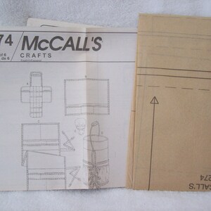 May include: A McCall's Crafts sewing pattern for a bag, with instructions and diagrams on a white sheet of paper. The pattern number is 4274.
