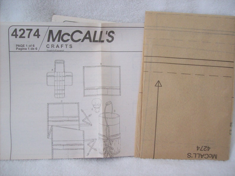 May include: A McCall's Crafts sewing pattern for a bag, with instructions and diagrams on a white sheet of paper. The pattern number is 4274.