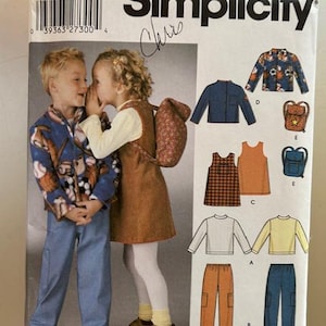 Può includere: Modello di cucito Simplicity numero 5284 per abbigliamento per bambini. Il modello include istruzioni per una giacca blu, un vestito a quadri e arancione, una camicia a maniche lunghe bianca e gialla, pantaloni arancioni e pantaloni blu.
