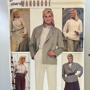 May include: A vintage sewing pattern for a wardrobe with three different looks. The pattern is for size 12 and features a white blouse with a grey jacket, a white blouse with a grey jacket and white pants, and a white blouse with a grey jacket and a burgundy skirt.
