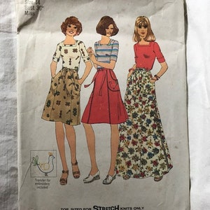 May include: Vintage Simplicity sewing pattern number 7895 for a size 14, bust 36 inches, miss. The pattern features three women wearing different styles of skirts with a transfer for embroidery included. The pattern is for stretch knits only.