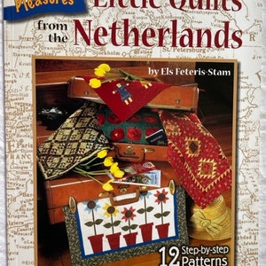 May include: Book cover featuring a colorful quilt design with the title "Little Quilts from the Netherlands" and the author's name "Els Feteris-Stam". The cover also includes a map of Europe and the text "Simple Pleasures" and "12 Step-by-step Patterns".
