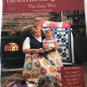 May include: A book cover featuring a woman and a child sitting in front of a fireplace. The book title is "Traditional Quilts II: The Easy Way" by Sharon Hultgren. The book cover features a variety of quilt patterns, including "Easy Angle", "Easy Angle II", "Easy Eight", "Easy Six", "Easy Hexagon", and "Companion Angle".