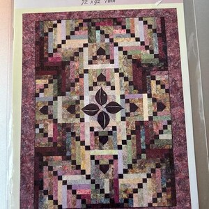 May include: A quilt pattern titled "Diamond Braid" with dimensions of 72 x 92 inches for a twin bed. The quilt design features a central floral motif and a geometric pattern in shades of brown, green, and purple. The designer's name, Trish Stuart, is also visible.