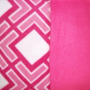 May include: A white fabric with a pink and light pink geometric pattern. The fabric is sewn together with a solid pink fabric.