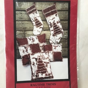 May include: A pattern for making ragtime trims, including stockings, square pillows, and rectangular pillows. The pattern includes instructions for making 15" and 20" stockings, 17" and 11" square pillows, and 12" and 15" rectangular pillows.