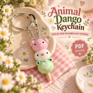 Könnte beinhalten: Ein Schlüsselanhänger mit drei gestapelten, tierförmigen Dango-Anhängern in Rosa, Weiß und Hellgrün, befestigt an einem silbernen Metallring. Der Text lautet Animal Dango Keychain, Step-by-Step Polymer Clay Tutorial und PDF Guide.
