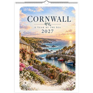May include: A 2027 wall calendar titled Cornwall: A Year by the Sea, featuring a coastal scene with stone cottages, colorful flowers, a harbor with small boats, and a sunset over the ocean, bound with a white metal spiral wire.
