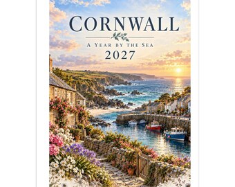 May include: A 2027 wall calendar titled Cornwall: A Year by the Sea, featuring a coastal scene with stone cottages, colorful flowers, a harbor with small boats, and a sunset over the ocean, bound with a white metal spiral wire.