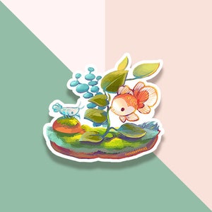 May include: A sticker featuring a whimsical illustration of a goldfish in a miniature aquatic scene. The goldfish is orange and white, surrounded by green plants and blue bubbles. The sticker has a white border and the text "THOUSANDSKIES" at the bottom.