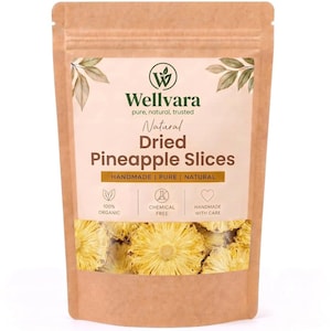 May include: A brown kraft paper stand-up pouch containing dried pineapple slices. The label features the text Wellvara, Natural Dried Pineapple Slices, 100% Organic, Chemical Free, and Handmade With Care, with a clear window showing the yellow fruit.