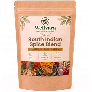 May include: A brown paper pouch containing a South Indian spice blend. The label features the Wellvara logo, text reading Natural South Indian Spice Blend, and icons for organic, chemical-free, and handmade. The bottom shows various spices.