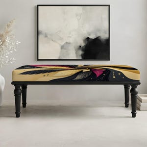 May include: A rectangular upholstered bench featuring a vibrant, swirling abstract pattern in shades of gold, deep magenta, and black. The bench is supported by four turned, matte black wooden legs, providing a stable base for the cushioned seat.