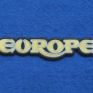Könnte beinhalten: Ein gestickter Aufnäher mit dem Wort "EUROPE" in einer stilisierten gelben Schriftart mit weißer Umrandung und einem dicken schwarzen Rand. Die Buchstaben sind in einem durchgehenden, schriftartigen Design verbunden und bilden ein Emblem.