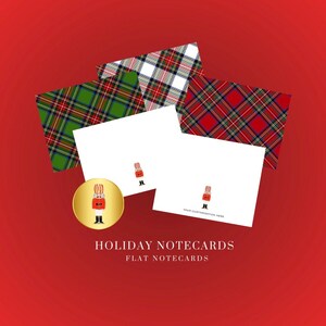 May include: Holiday notecards with a red background. The image features white flat notecards with a cartoon illustration and plaid patterned cards. A gold coin with a cartoon illustration is also present. Text on the image reads "Holiday Notecards" and "Flat Notecards."