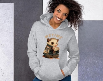 May include: A light gray hooded sweatshirt featuring a graphic of an opossum wearing a patterned sweater and holding a mug, with the text "METIME" arched above the animal. The hoodie includes a front kangaroo pocket and long sleeves.