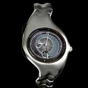 May include: A silver-toned wristwatch with a fluid, asymmetrical metal band and a round dark grey dial. The face features a central sunburst pattern, two sub-dials, and white text reading START/STOP, LAP/RESET, and SET MODE around the bezel.
