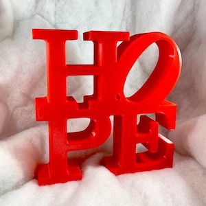 May include: Red, three-dimensional, freestanding "HOPE" sign. The letters are interlocking and the "O" is a circle.