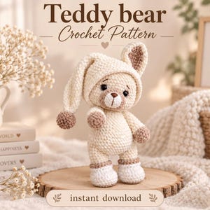 May include: A crochet teddy bear wearing a cream-colored nightcap with a brown pom-pom, featuring brown accents on the ears, paws, and nose. The text reads Teddy bear Crochet Pattern and instant download, with books labeled A Kinder World.