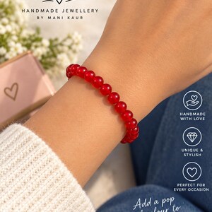 May include: A red beaded bracelet made of smooth, round, translucent stones. The text on the image reads: Mayas Wristlets, HANDMADE JEWELLERY BY MANI KAUR, HANDMADE WITH LOVE, UNIQUE & STYLISH, PERFECT FOR EVERY OCCASION, Add a pop of colour to your day.