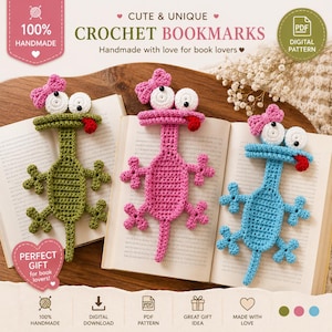 May include: Three crochet bookmarks shaped like lizards in olive green, pink, and light blue. Each lizard features large white eyes with black pupils, a small pink bow on its head, and a red tongue sticking out. They are displayed on open books.