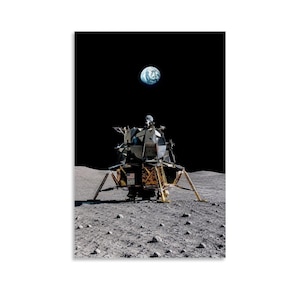 May include: A lunar module stands on the gray, cratered surface of the moon. The spacecraft features gold-colored foil panels and metallic structural components. Above the module, the blue and white Earth is visible against a black sky.