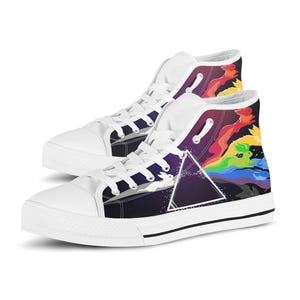 May include: High-top sneakers with white laces, white rubber toe caps, and white soles. The canvas sides feature a dark purple space background with a white triangle prism refracting a white rabbit into a spectrum of colorful, leaping rabbits.