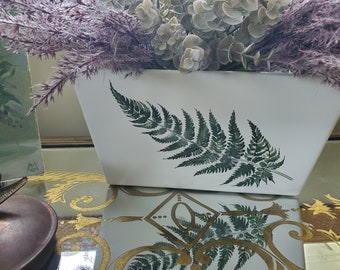 White all wood decor box with finger holes, fern leaf transfer on one side, blank on the other.