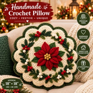 May include: A round, cream-colored crochet pillow featuring a central red poinsettia flower with yellow centers, surrounded by a wreath of green leaves and red and white berries. The pillow measures approximately 18 inches by 18 inches.