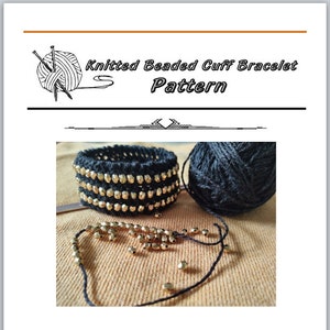 May include: A black knitted beaded cuff bracelet pattern with gold beads. The image shows a close-up of the bracelet, a ball of black yarn, and some loose beads.