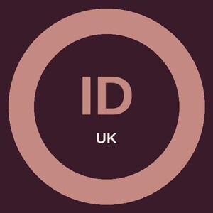 May include: A circular graphic design featuring a dark purple center with the letters ID in a light pink sans-serif font. Below the letters, the letters UK appear in a smaller white font. The entire design is enclosed by a thick light pink border.