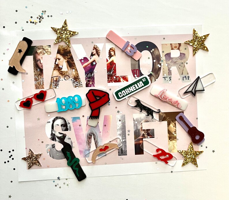 May include: A collection of colorful acrylic cutouts featuring the word "TAYLOR SWIFT" with various album titles and song lyrics, including "1989", "Cornelia Street", "Lover", and "Fearless".