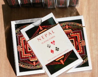 May include: Five vertical decks of cards labeled MARRIAGE and one labeled CALL BREAK in red text, plus two horizontal decks labeled NEPAL PLAYING CARDS with a black, red, and gold geometric design and the text KINGS, QUEENS, LEGENDS.