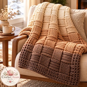 May include: A chunky knit throw blanket featuring a basketweave pattern with an ombre color gradient transitioning from dark brown at the bottom to light cream at the top. The blanket includes a circular logo with the text Crochet Dream By Zin.