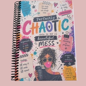 May include: A spiral-bound notebook with a colourful cover featuring the text Perfectly CHAOTIC this is my beautiful MESS. The design includes various handwritten notes, doodles, hearts, and an illustration of a person wearing sunglasses.