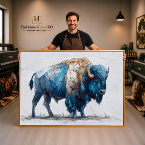 May include: A large rectangular canvas print featuring an impasto-style oil painting of a bison. The bison is rendered in shades of deep blue, white, and tan with visible thick brushstrokes. The artwork is encased in a thin, light-colored wooden frame.